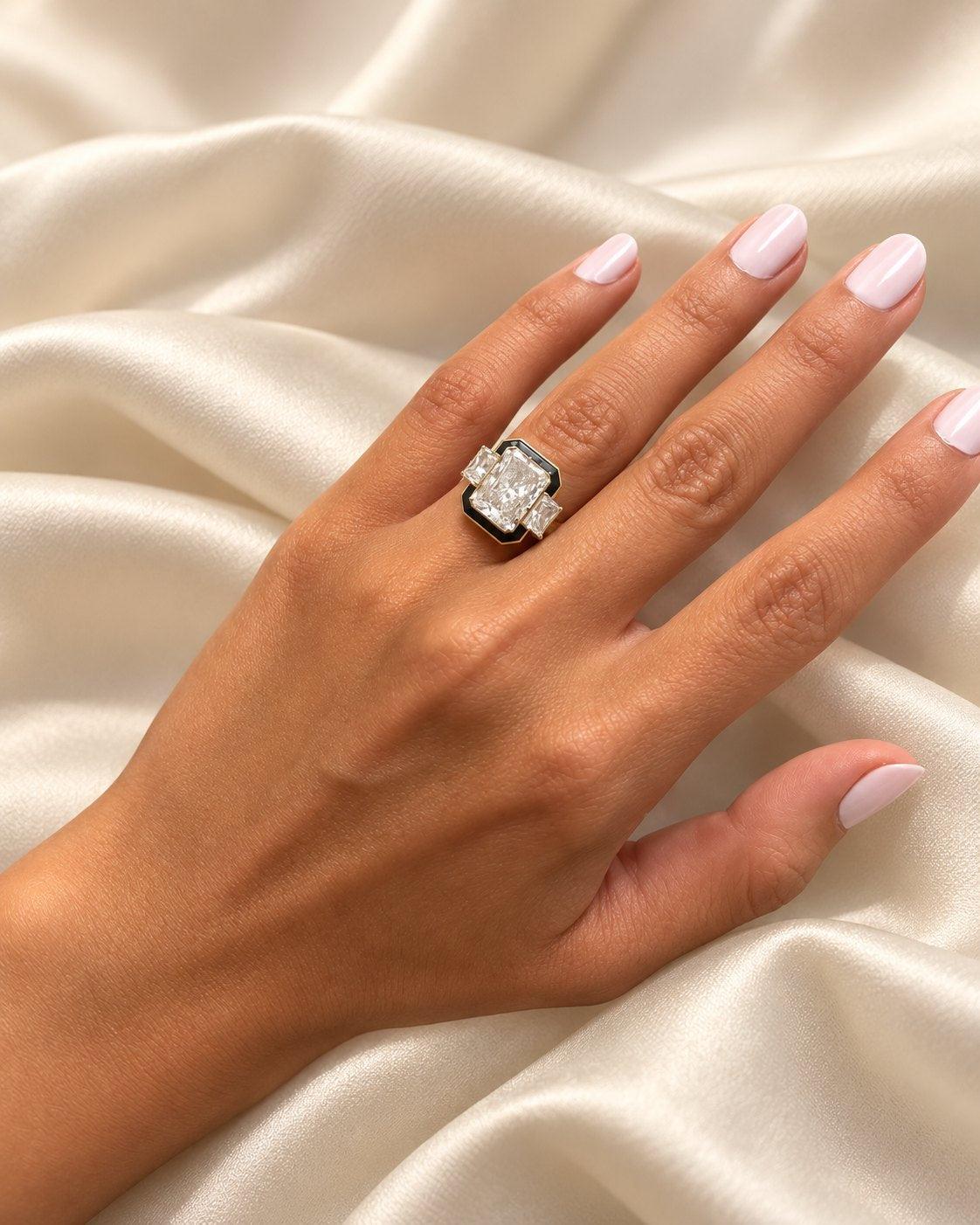 Bespoke radiant-cut diamond ring with black enamel on the hand