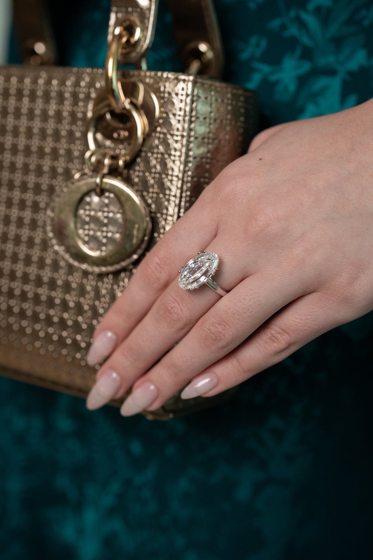 Diamond jewelry worn with a handbag