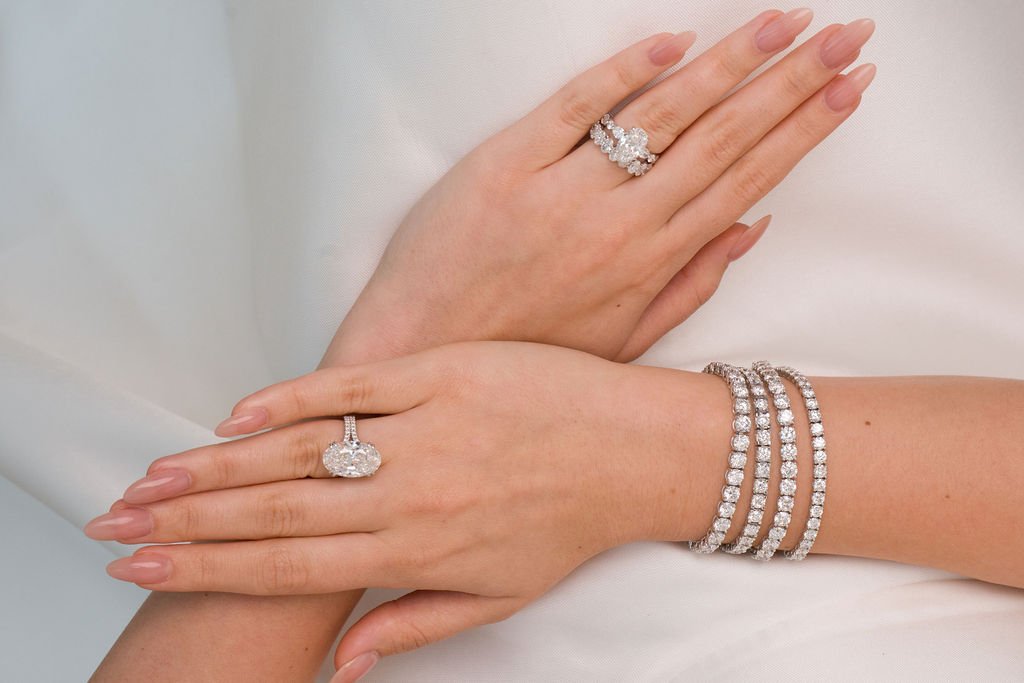 Stellar Gems lab-grown diamond bracelet and two rings, crossed hands